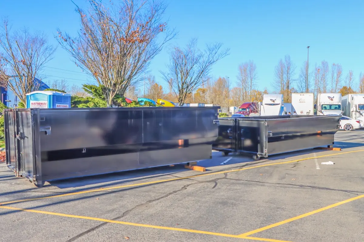Professional dumpster rental service with roll-off container on residential driveway in Marina
